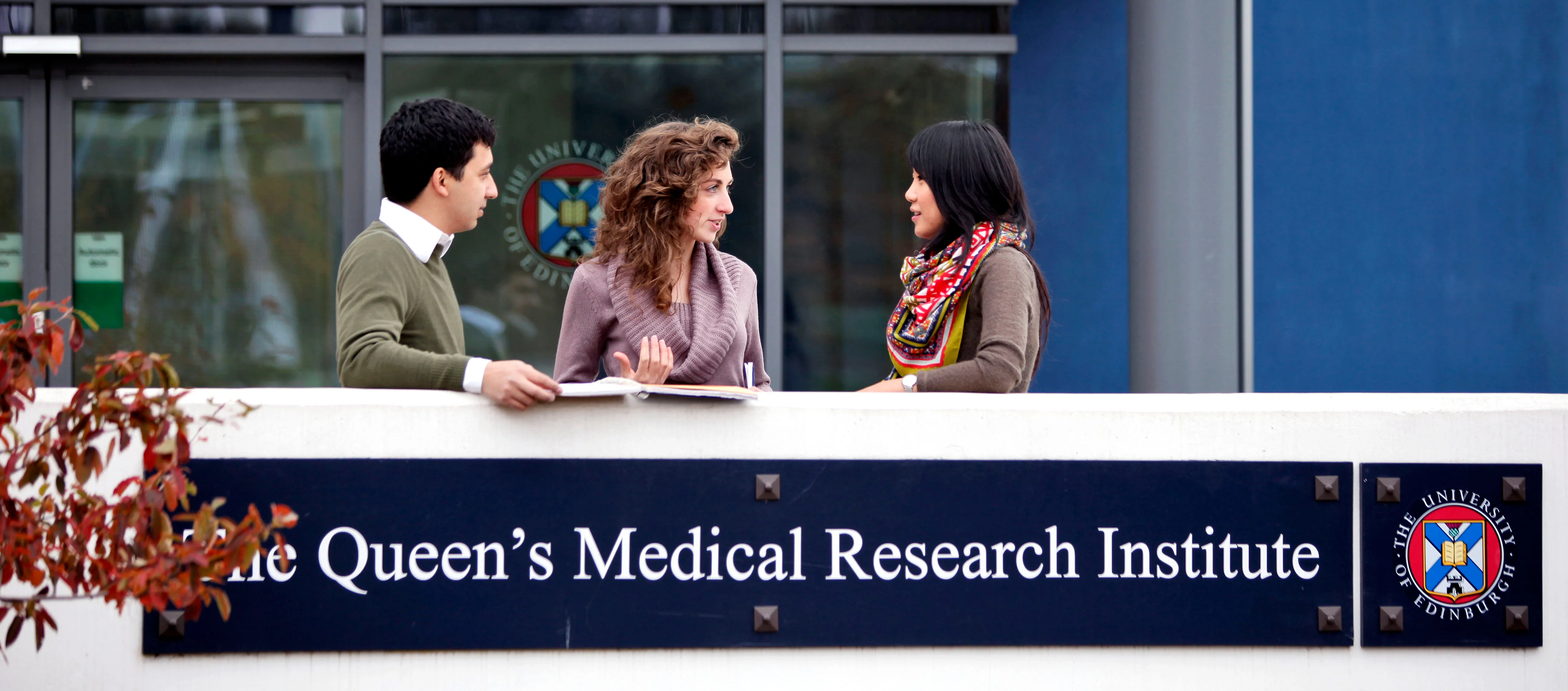 3 students outside of QMRI building